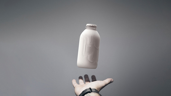 Hand Catching a White Liquid Container