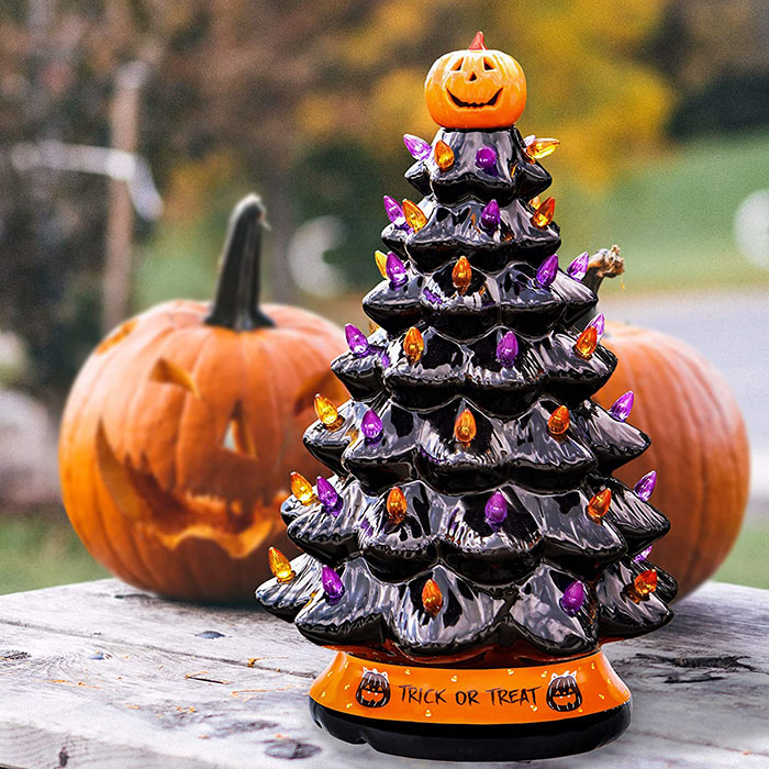 black halloween tree with jack-o-lanterns in the background