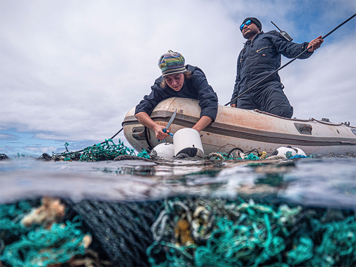 crew removes floating fishing nets