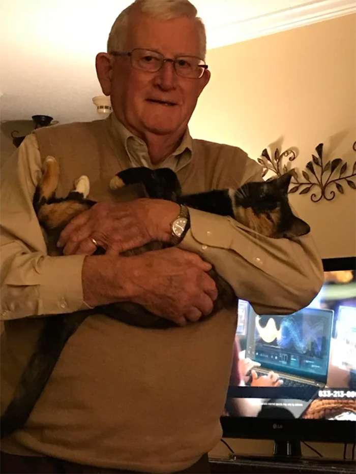 dad carries his cat to bedroom every night