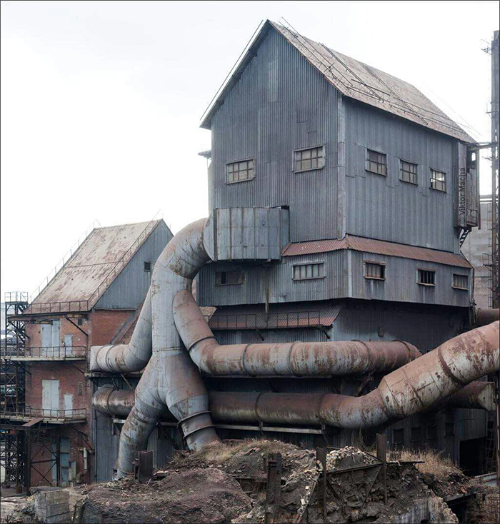 giant tin man checking a building