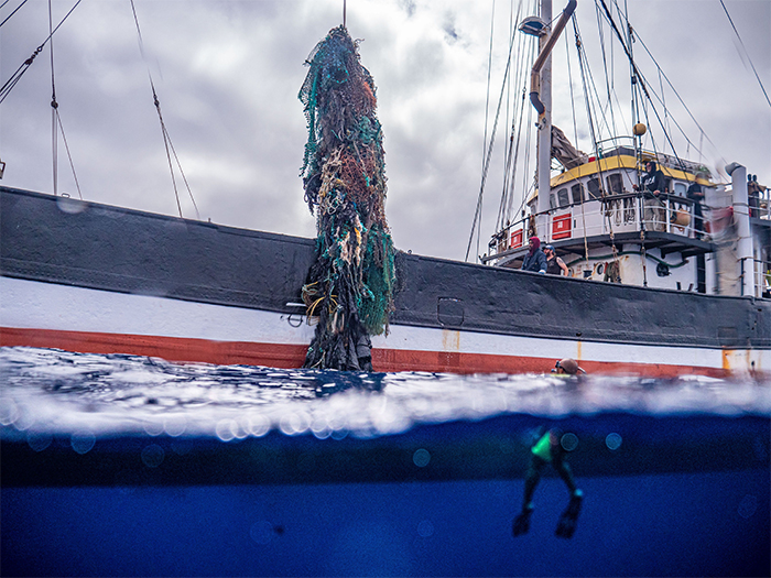 large net lifted by vessel crane