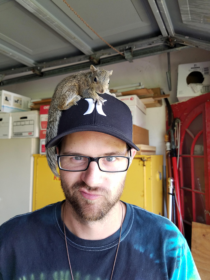 squirrel on a man's head