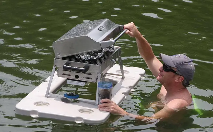 man opening a bbq grill on floating bar