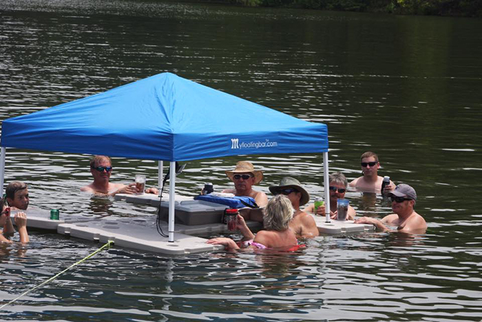 people gathered around a floating bar