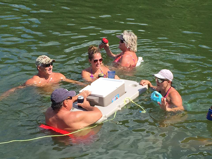 people in pool with connectable cooler float