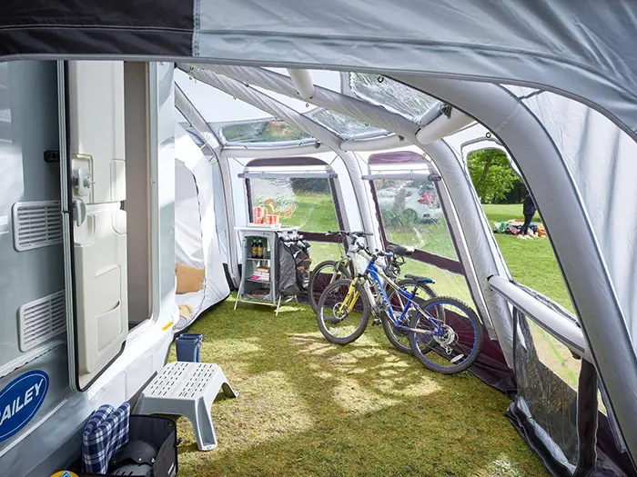 bicycles parked under an rv awning