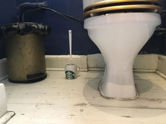 funny shops independent coffee shop uses starbucks mug as toilet brush holder