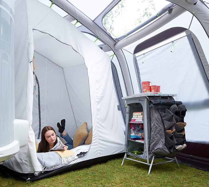 lady reading a magazine while lying on an inner sleeping tent