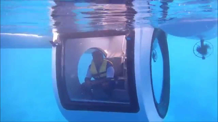 lone man sits inside the submarine