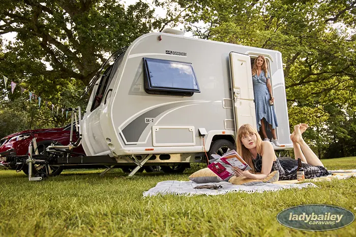 two ladies outdoor with a bailey discovery d4-2 camper trailer