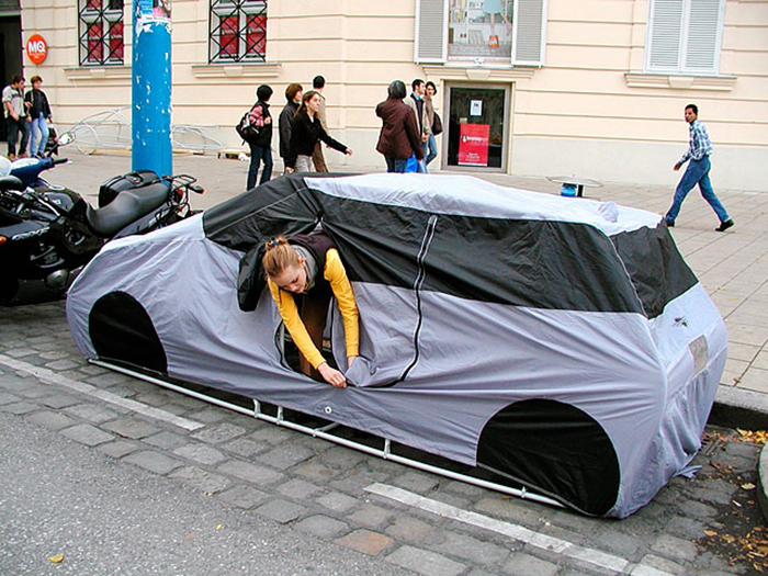 woman setting up a car-shaped tent