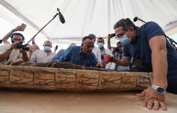 Dr Al-Anani and a researcher study the mummy