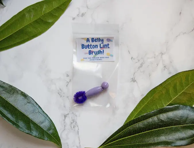 belly button lint brush in purple