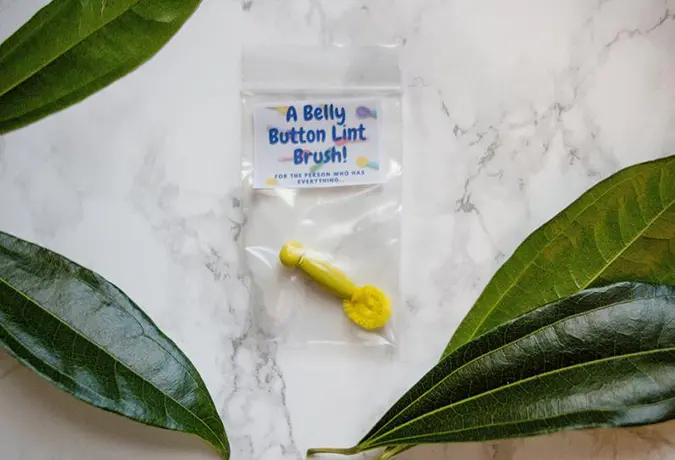 belly button lint brush in yellow