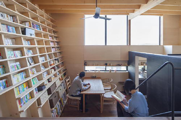 couple reads next to their earthquake-proof bookshelf