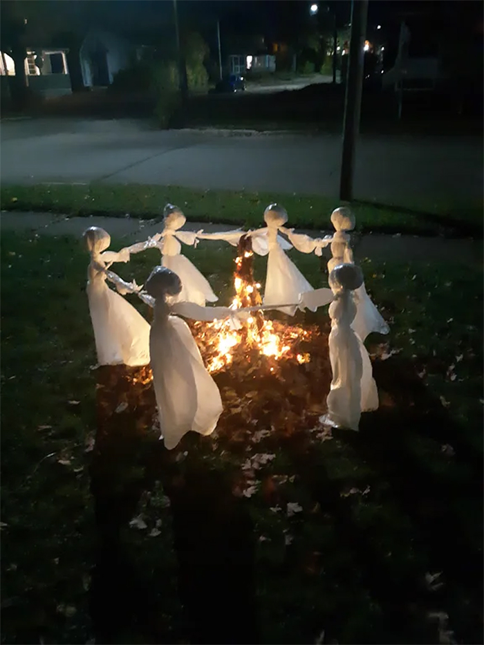 ghostly figures around a bonfire