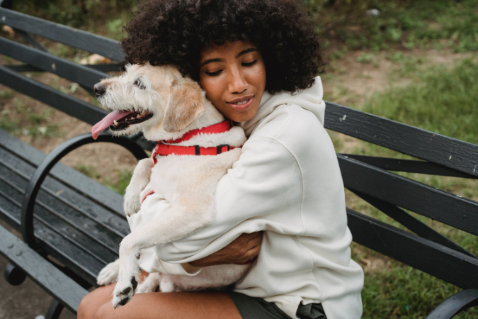 girl cuddles with her dog