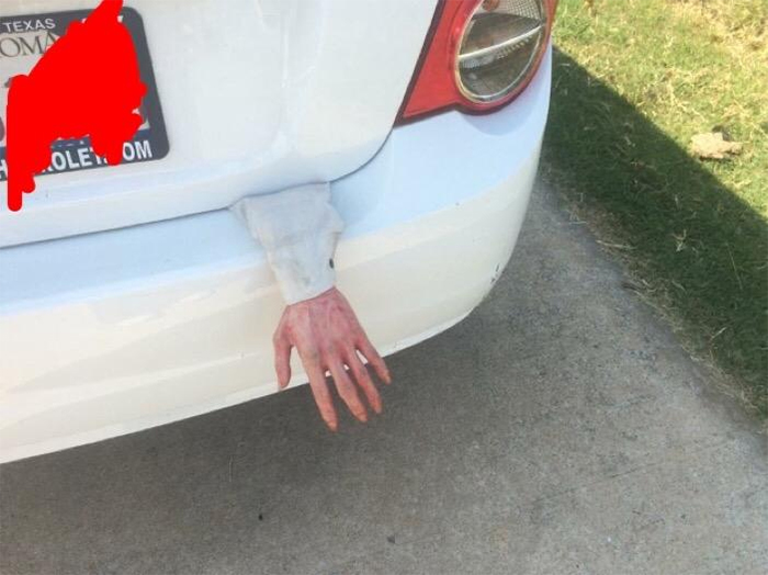 hand sticking out of car compartment