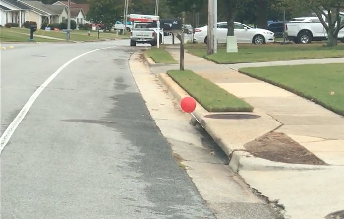 it-inspired balloon in the sewer