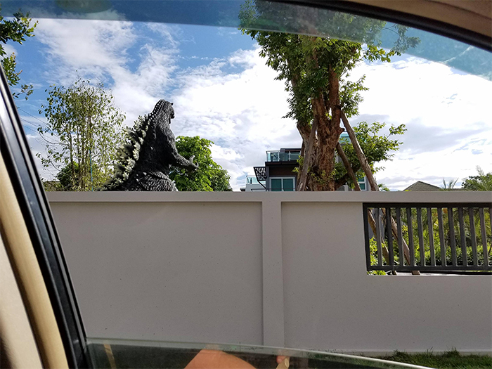 neighbor giant godzilla statue