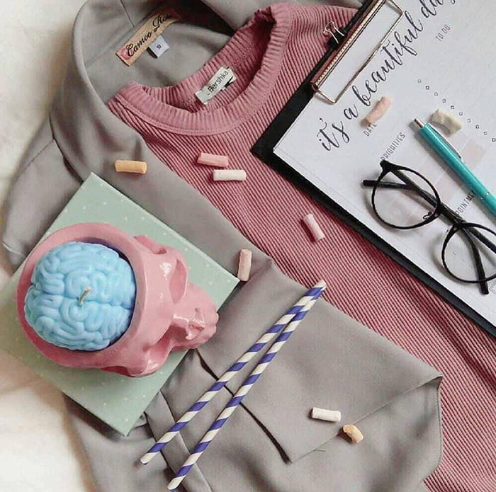 pastel blue brain candle in pink cranium-inspired holder