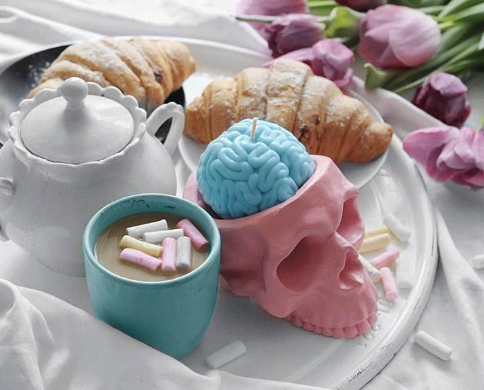 pastel blue human brain candle in pink skull holder