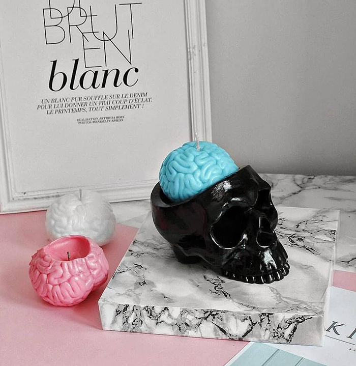 pastel-colored human brain candles and black skull holder