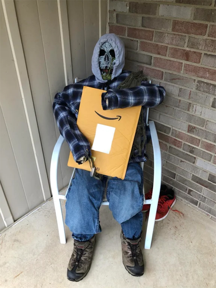 spooky figure holding a package