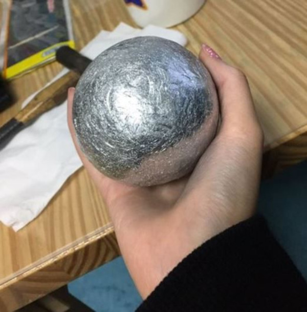 aluminum foil ball in crafter's hand