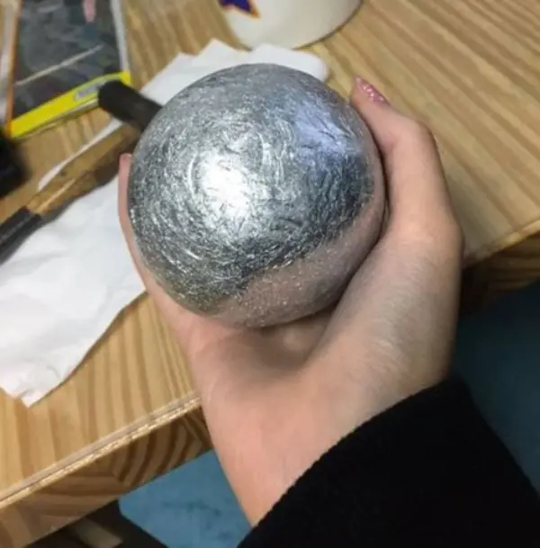 aluminum foil ball in crafter's hand