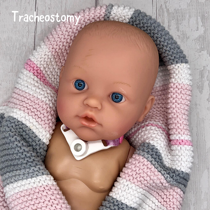 baby doll with tracheostomy