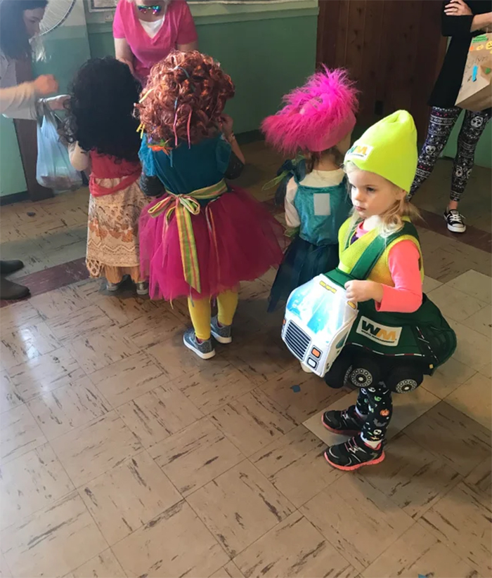 little girl in garbage truck outfit