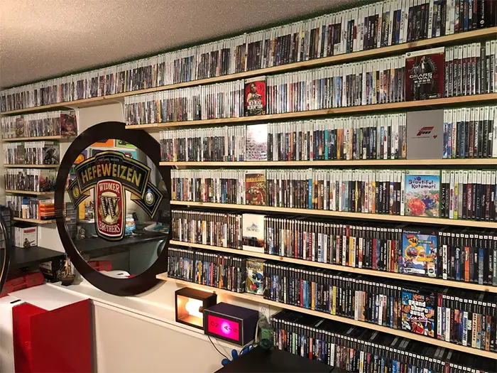 wife builds shelves for husband game collection