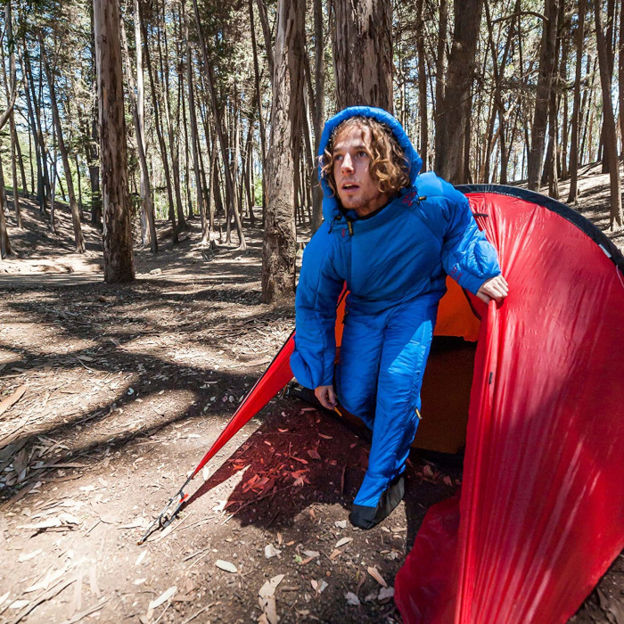 camper emerges from his tent wearing the onesie