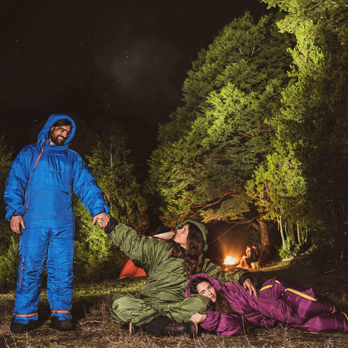 campers in blue green and purple sleeping bag onesie suits