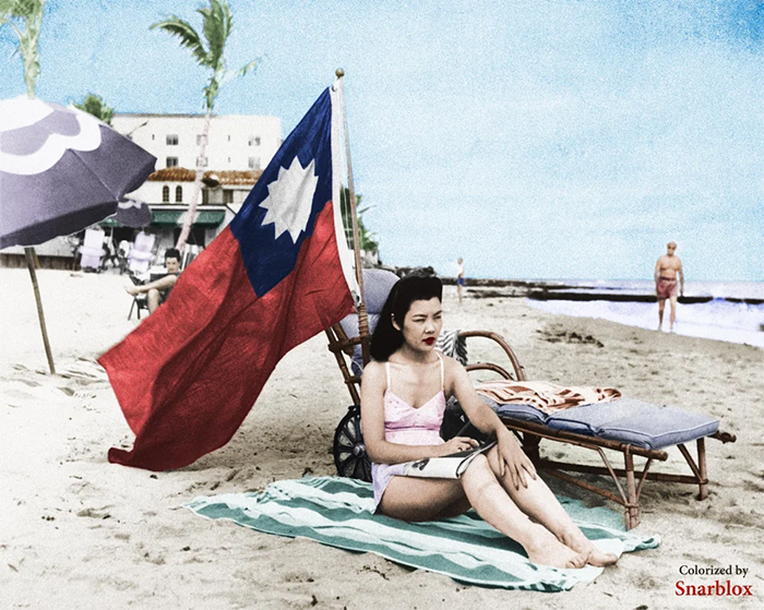 chinese woman sunbathes in miami with china flag