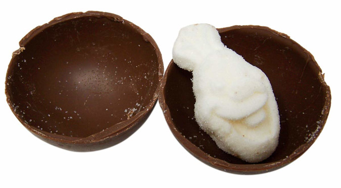 hot chocolate bomb cut in half to reveal olaf-shaped marshmallow