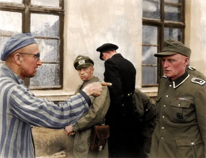 russian prisoner points at cruel nazi guard