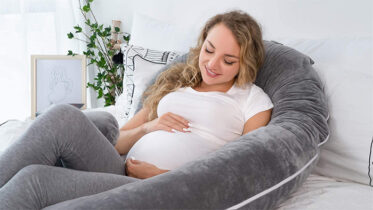 This C-Shaped Pregnancy Pillow Supports Your Bump While You Sleep