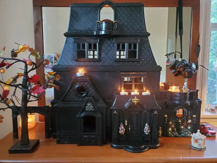 the black dollhouse staged for halloween