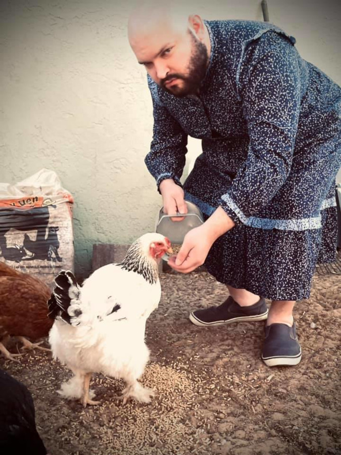 Thomas Henrich feeds a chicken while roasting Target