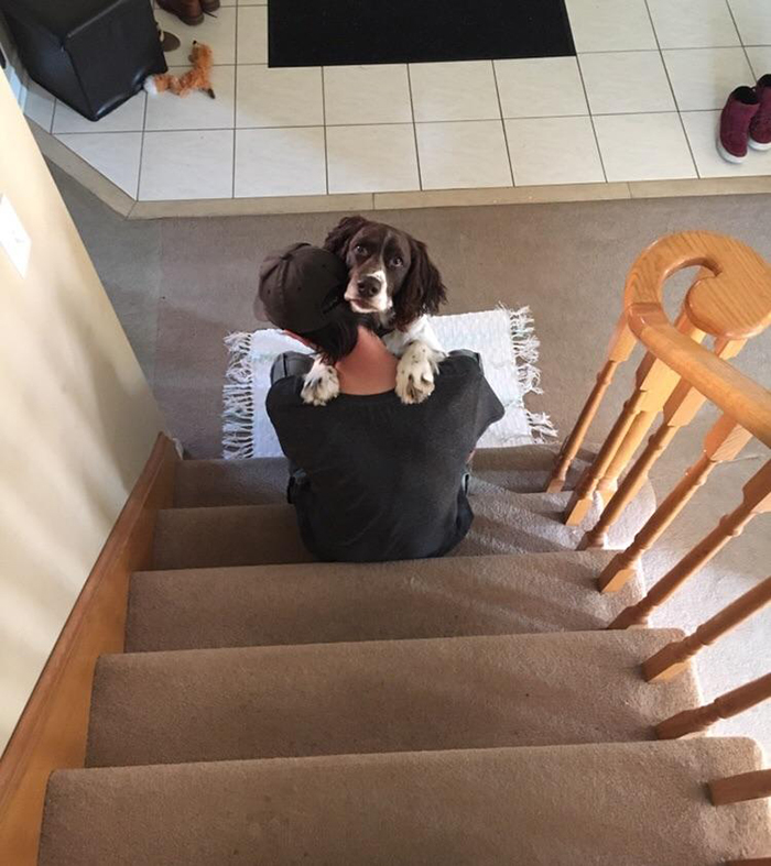 boyfriend giving dog hug