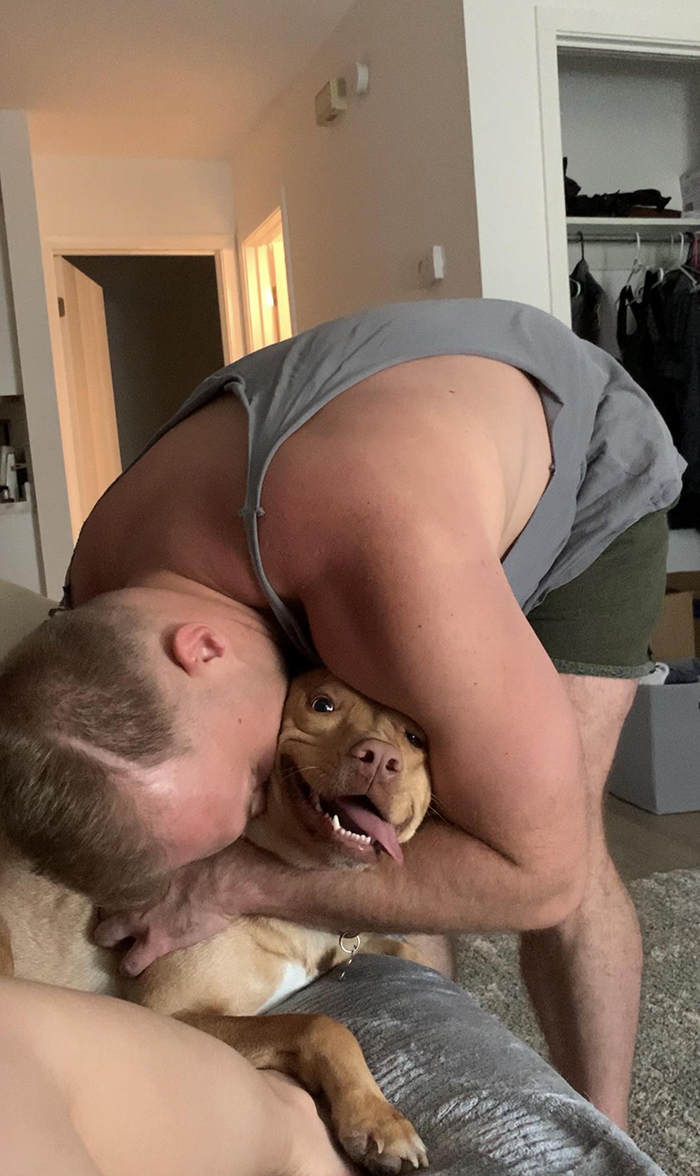 dog receiving hug from owner's boyfriend