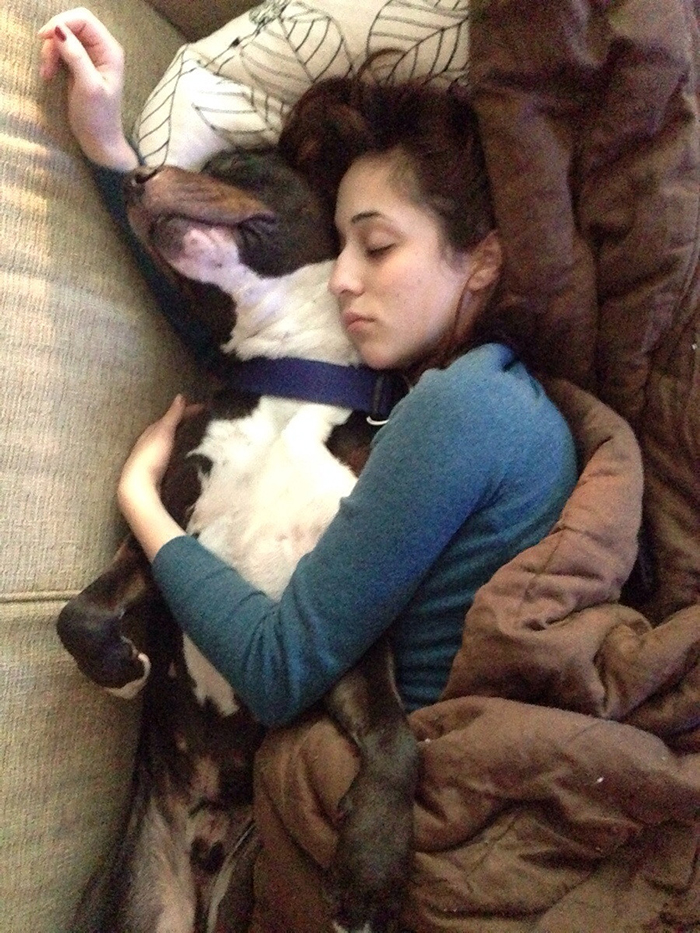girlfriend sleeping while hugging dog
