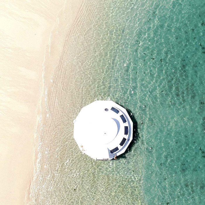 aerial shot of the Anthenea by the sea shore