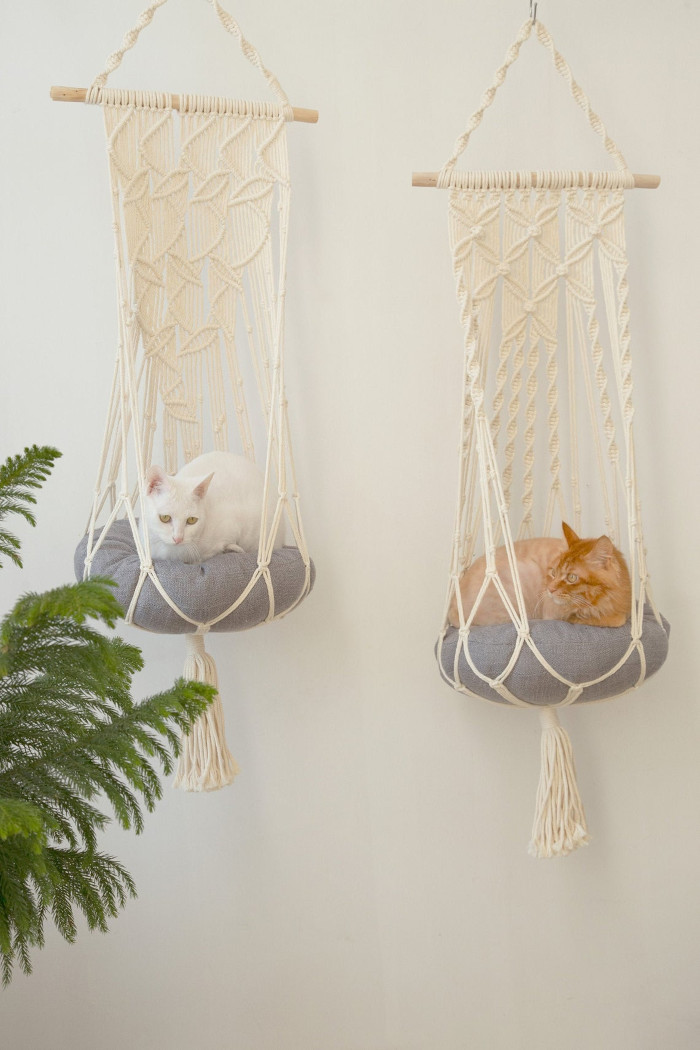 leaf and flower-patterned hanging cat hammocks side by side