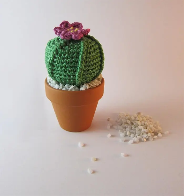 crocheted faux plant with decorative pebbles