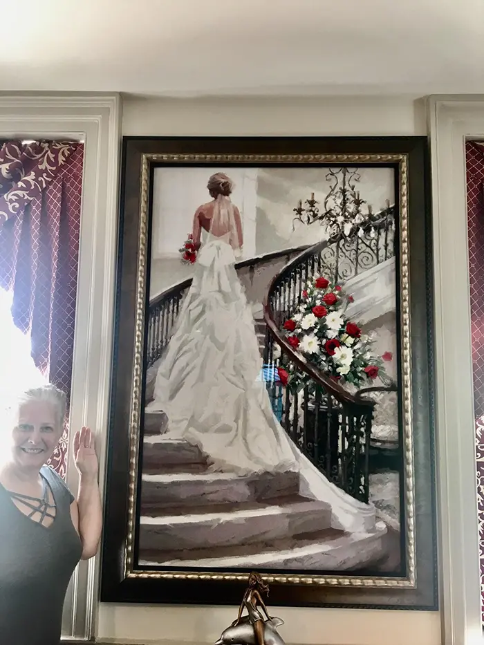 cross-stitch art bride standing on stairs