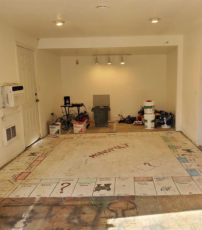 giant monopoly board painted onto floor old house